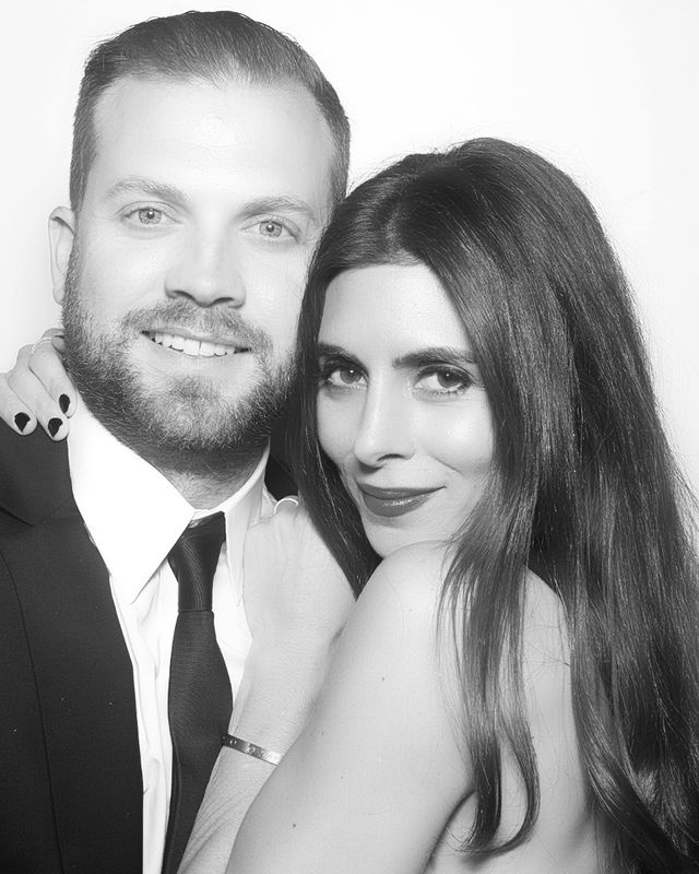 Cutter Dykstra in a black formal dress smiling with his wife.